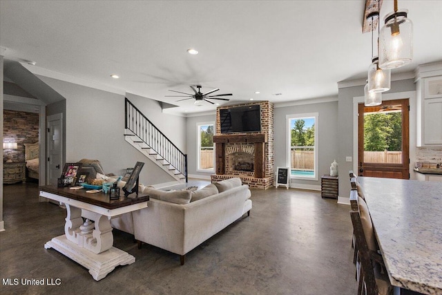 1254 Wade Patrick Rd, Brandon, MS 39042 - living room featuring a fireplace, ornamental molding, recessed lighting, plenty of natural light, and a ceiling fan