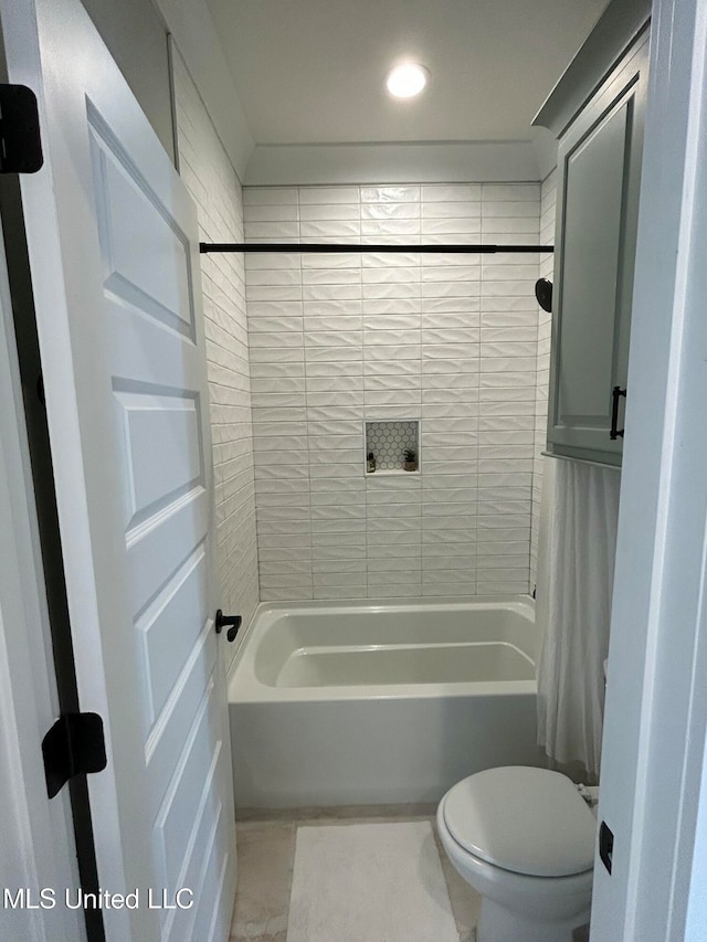 bathroom with tile patterned flooring, shower / bathtub combination with curtain, and toilet