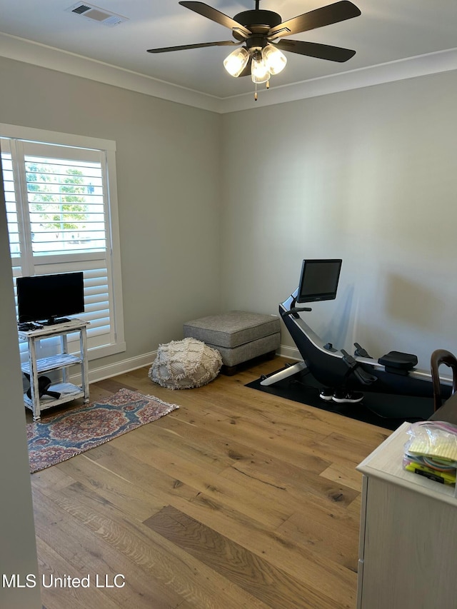 home office featuring hardwood / wood-style floors, ornamental molding, and ceiling fan