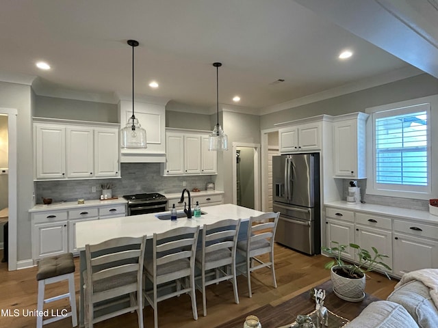 kitchen featuring stove, stainless steel fridge with ice dispenser, and white cabinets