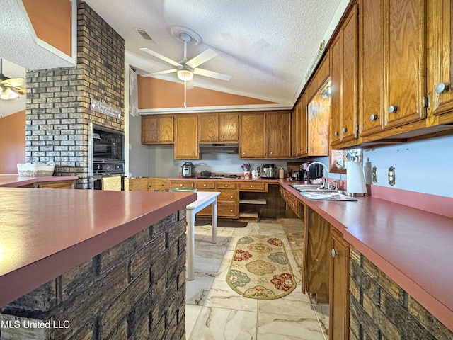 kitchen featuring a textured ceiling, ceiling fan, and lofted ceiling