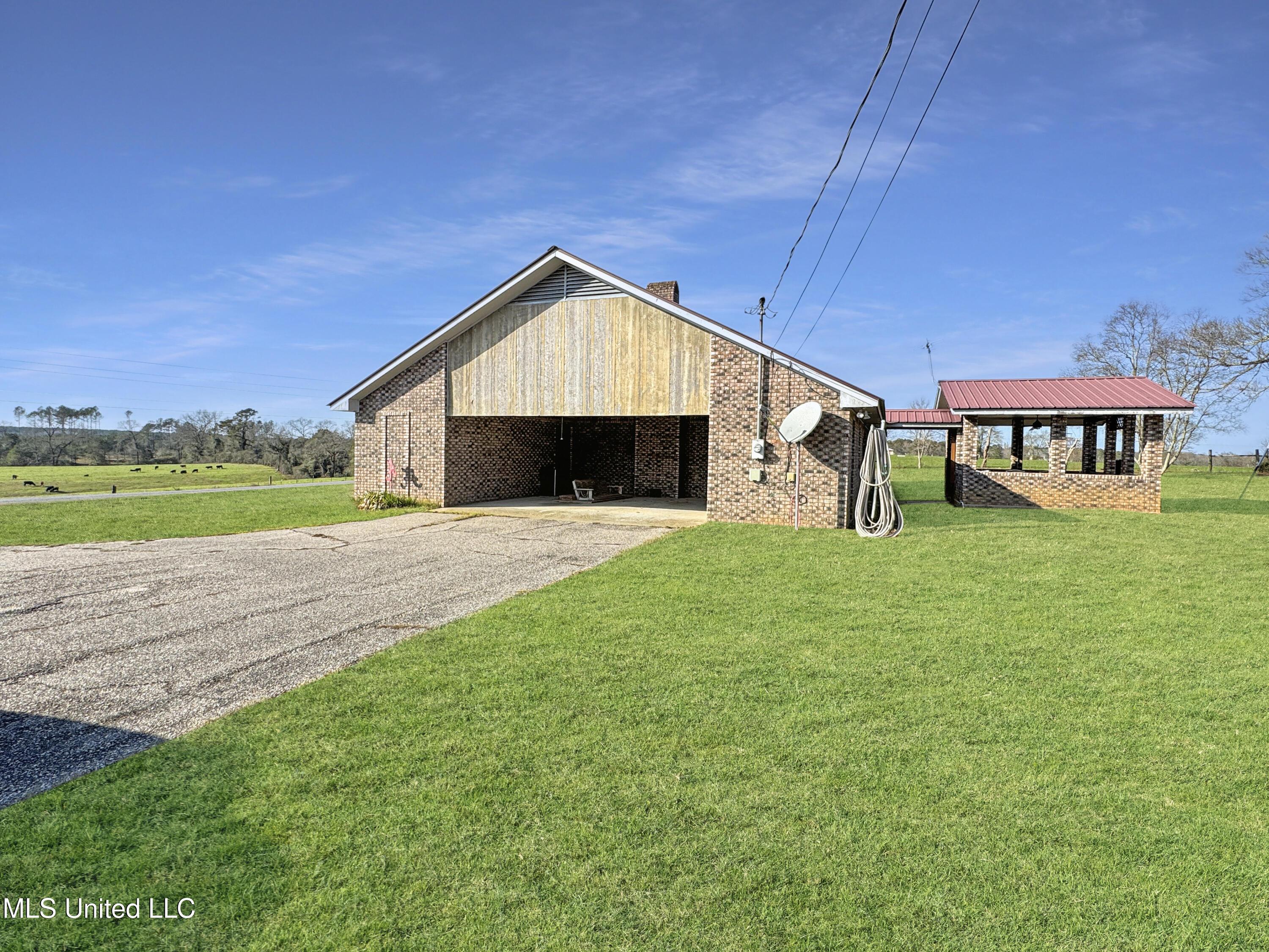 view of home's exterior featuring an outbuilding and a yard