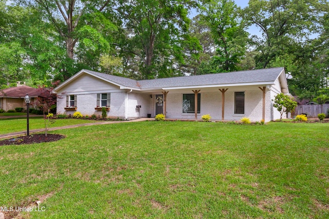 ranch-style home featuring a porch, brick siding, and a front lawn