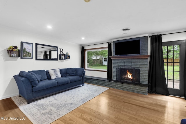 living area with plenty of natural light, a fireplace, recessed lighting, and wood finished floors