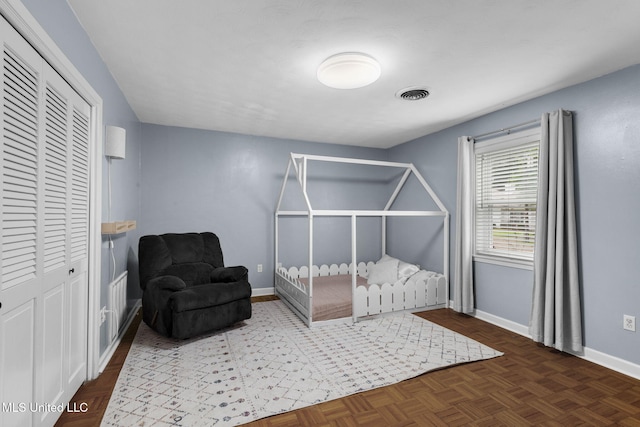 bedroom featuring baseboards, a closet, and visible vents