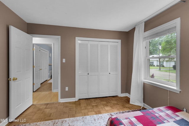 bedroom featuring baseboards and a closet