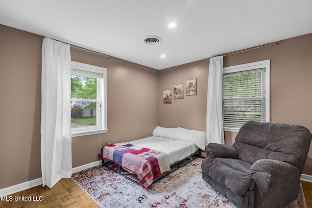 bedroom with baseboards, recessed lighting, and visible vents