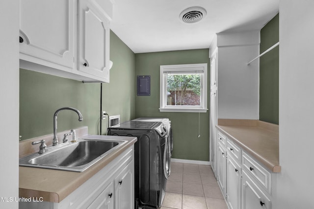 washroom with washer and dryer, light tile patterned flooring, cabinet space, a sink, and visible vents