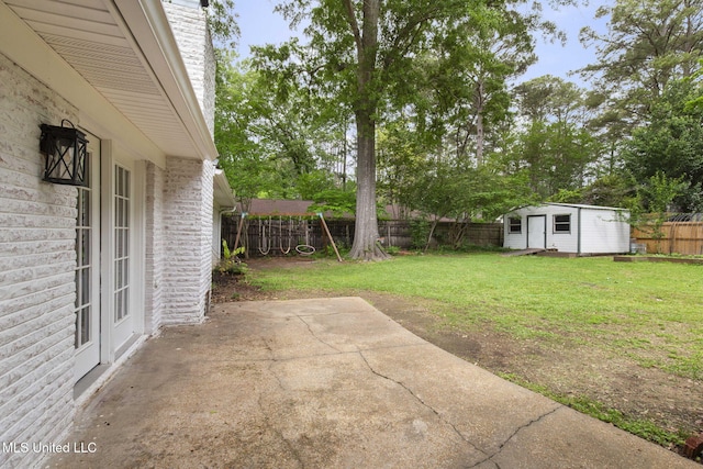 view of yard featuring a storage shed, a patio, an outbuilding, and a fenced backyard