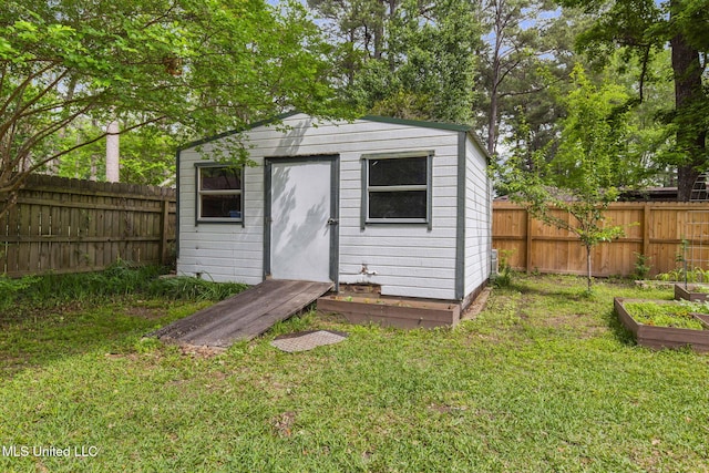 view of shed featuring a fenced backyard and a garden