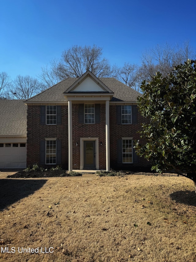 greek revival inspired property with a front yard