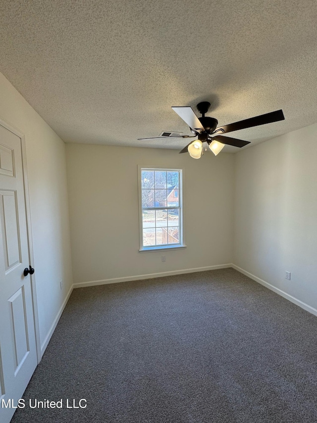 carpeted empty room with ceiling fan and a textured ceiling