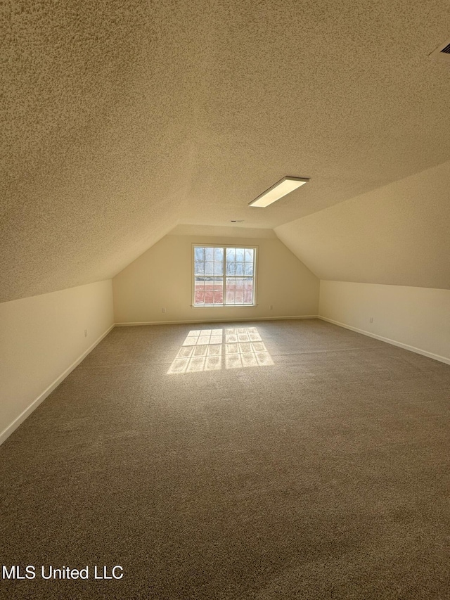 bonus room with carpet flooring, a textured ceiling, and lofted ceiling