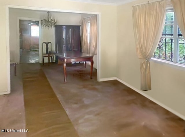 interior space featuring crown molding and an inviting chandelier