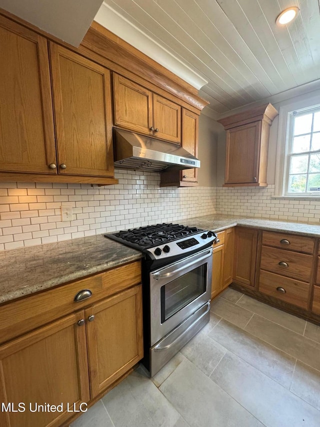 kitchen featuring light tile patterned floors, light stone countertops, wood ceiling, decorative backsplash, and stainless steel range with gas stovetop