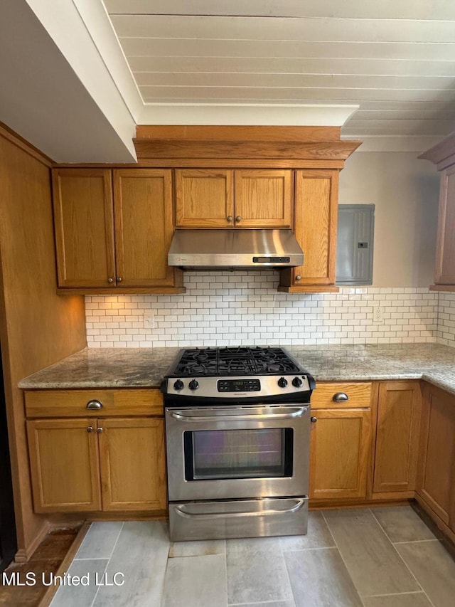 kitchen with electric panel, tasteful backsplash, stainless steel range with gas cooktop, and light stone countertops