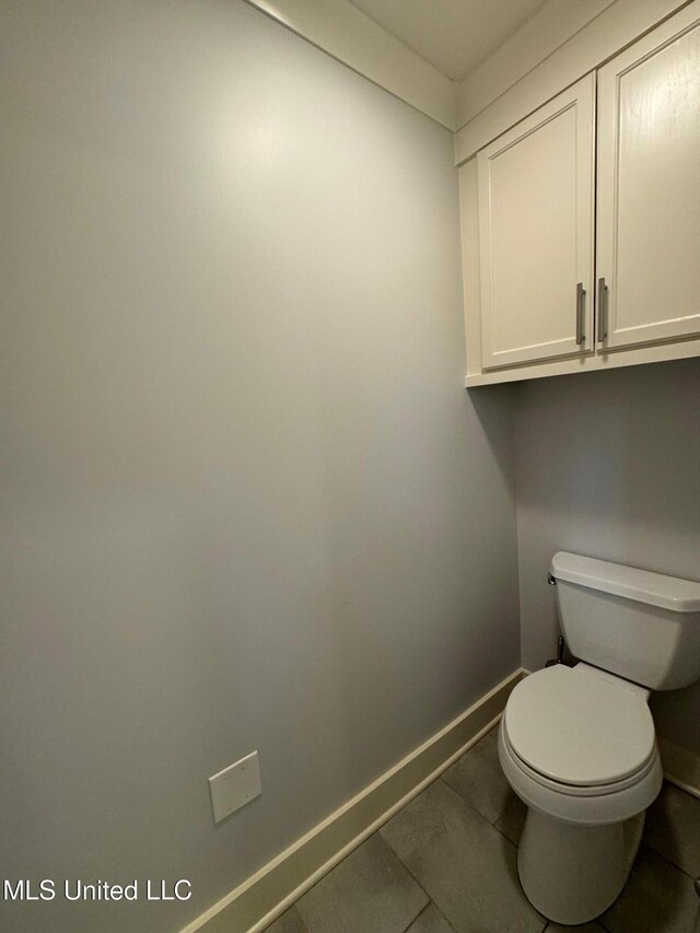 bathroom featuring toilet and tile patterned floors