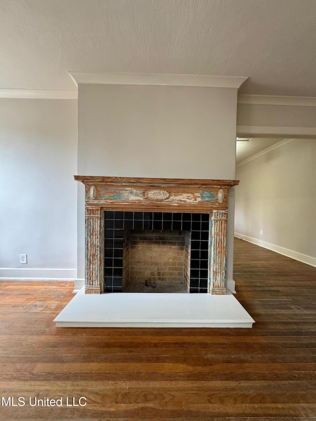 details featuring wood-type flooring, crown molding, and a fireplace