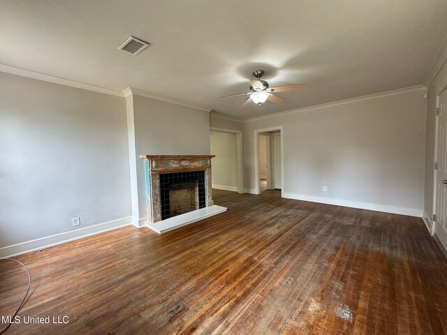 unfurnished living room featuring dark wood-type flooring, ceiling fan, a tile fireplace, and crown molding