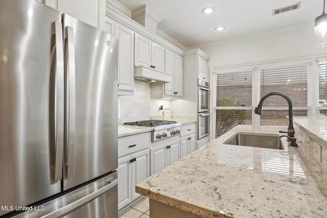 kitchen featuring white cabinetry, appliances with stainless steel finishes, sink, and custom range hood