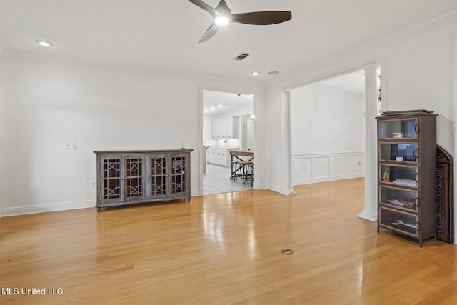 unfurnished room featuring crown molding, ceiling fan, and light hardwood / wood-style floors