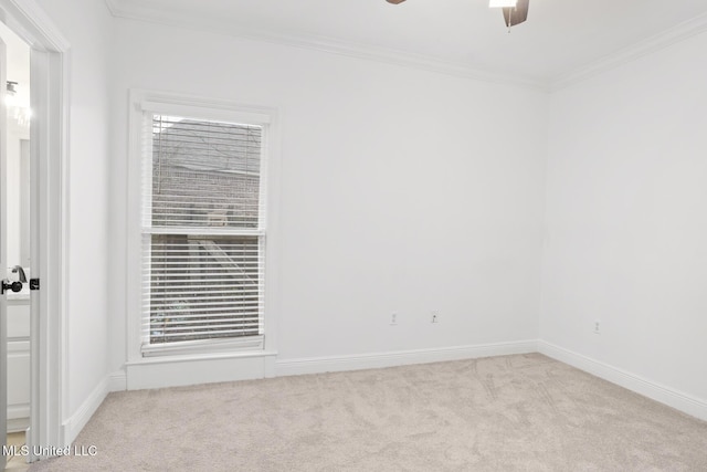 carpeted spare room featuring ornamental molding and ceiling fan