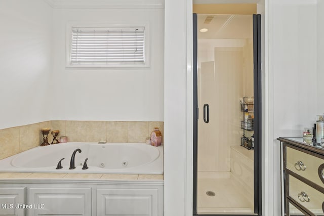 bathroom featuring independent shower and bath