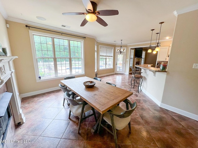 dining room featuring crown molding, tile patterned flooring, a fireplace, and visible vents