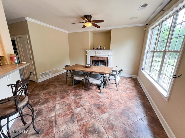 dining area with baseboards, visible vents, ceiling fan, and a fireplace