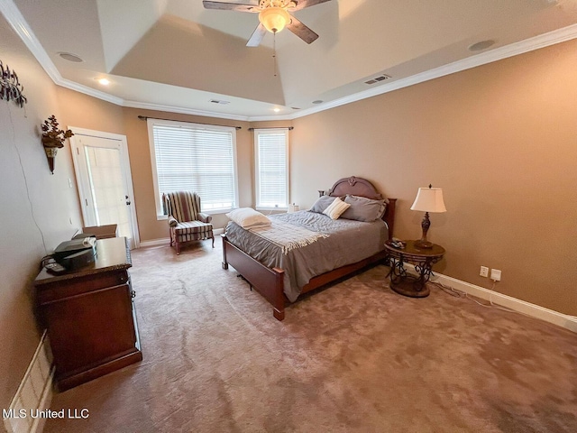 bedroom featuring crown molding, carpet floors, and a tray ceiling