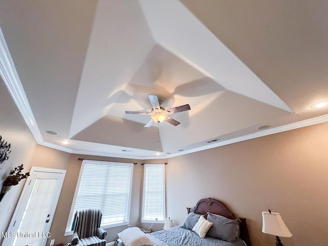 bedroom featuring ceiling fan, visible vents, crown molding, a tray ceiling, and recessed lighting