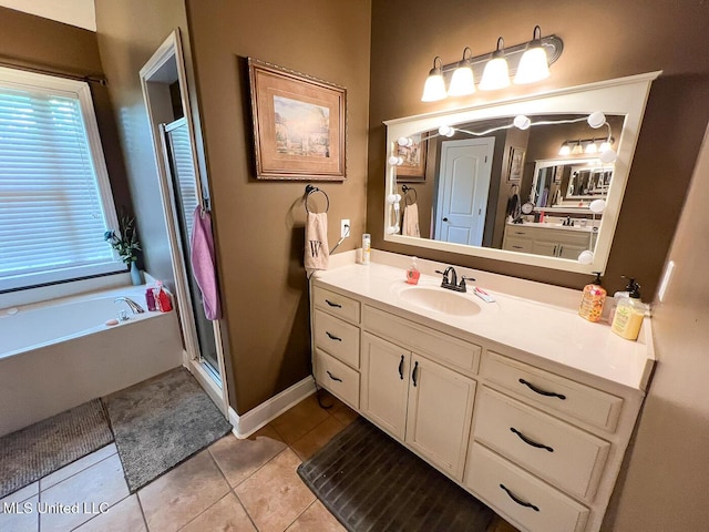 full bath featuring vanity, a garden tub, baseboards, tile patterned floors, and a shower stall