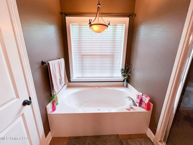 full bathroom with a tub with jets