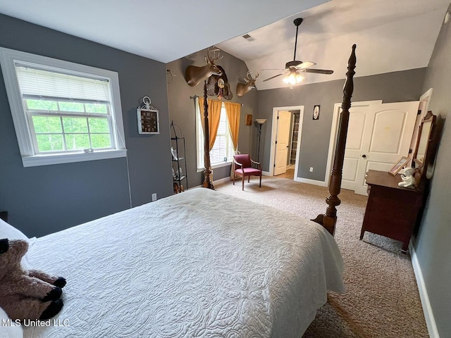 bedroom with carpet floors, baseboards, and vaulted ceiling