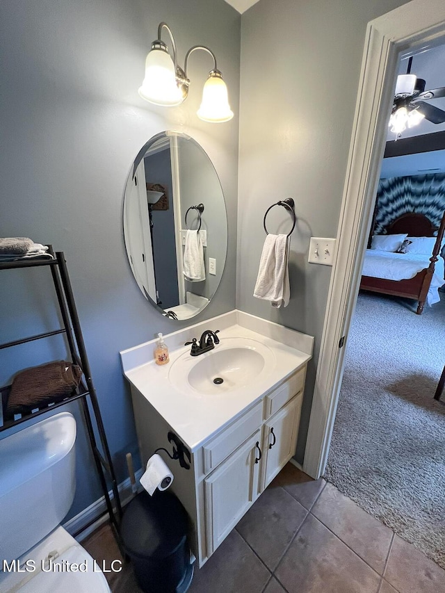 bathroom with tile patterned flooring, ensuite bathroom, toilet, and vanity
