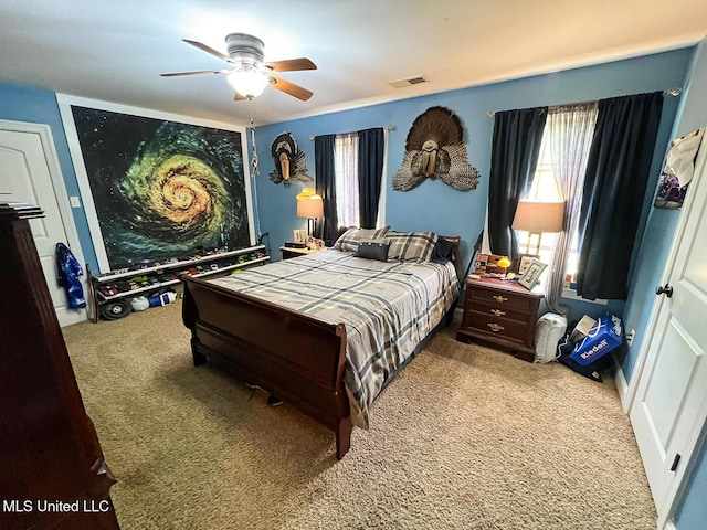 carpeted bedroom featuring visible vents and ceiling fan
