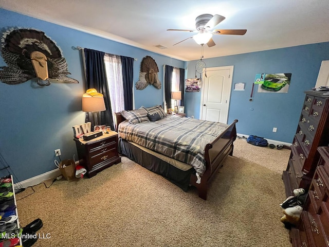 bedroom featuring visible vents, carpet flooring, baseboards, and a ceiling fan