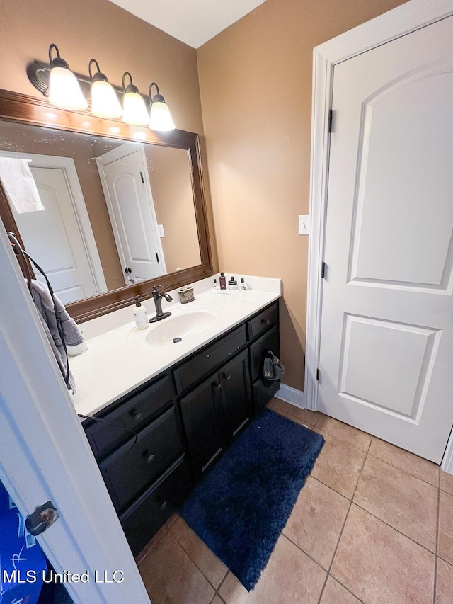 bathroom with tile patterned floors and vanity