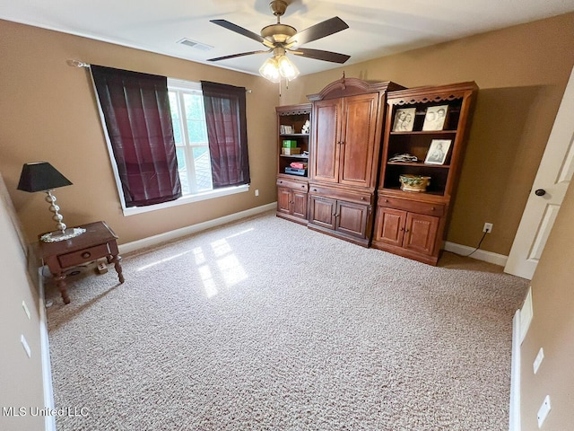 bedroom with visible vents, a ceiling fan, baseboards, and light carpet