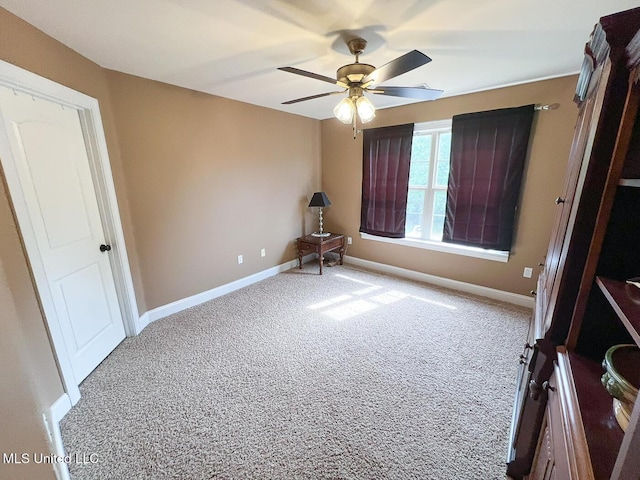 unfurnished bedroom with baseboards, a ceiling fan, and carpet flooring