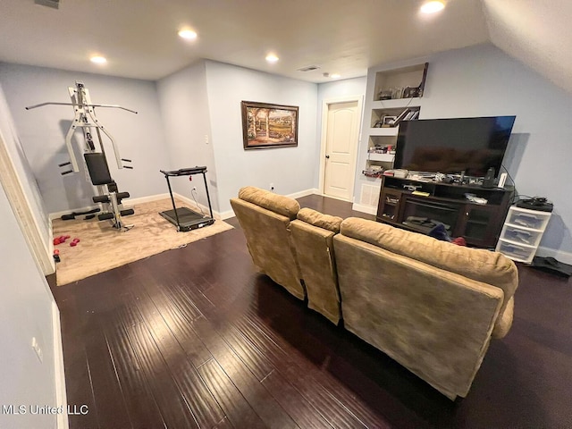 living room featuring built in shelves, recessed lighting, baseboards, visible vents, and hardwood / wood-style flooring