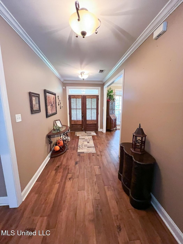 entryway featuring crown molding, baseboards, wood finished floors, and french doors