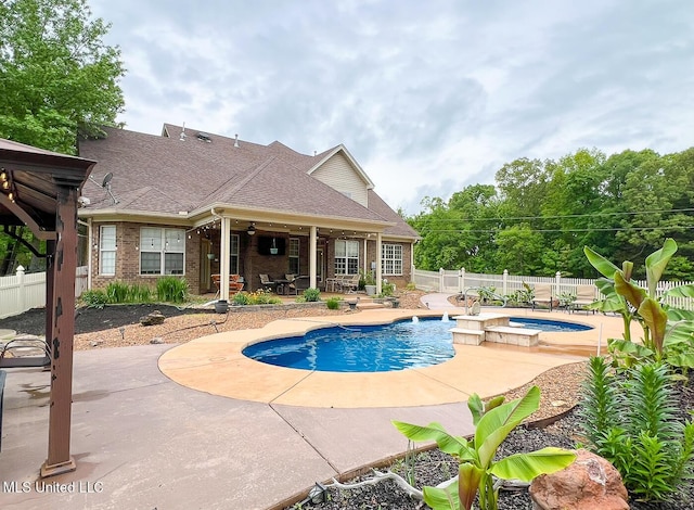 view of swimming pool with a fenced backyard, a patio area, and a pool with connected hot tub