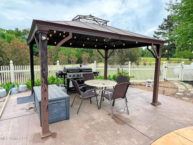 view of patio featuring outdoor dining space, a gazebo, area for grilling, and fence private yard