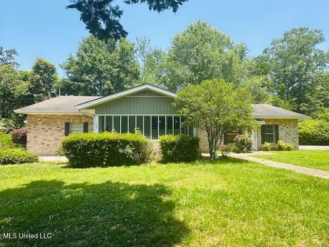 1561 Section Line Rd, Picayune, MS 39466 - view of front facade featuring brick siding, a front yard, and board and batten siding