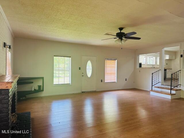 1561 Section Line Rd, Picayune, MS 39466 - unfurnished living room featuring wood finished floors, a ceiling fan, baseboards, and stairway