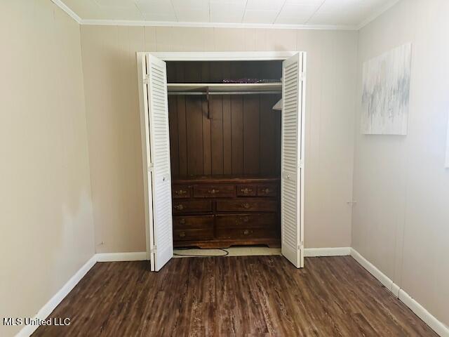 1561 Section Line Rd, Picayune, MS 39466 - unfurnished bedroom with ornamental molding, baseboards, wood finished floors, and a closet