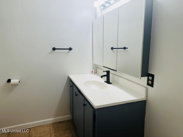 1561 Section Line Rd, Picayune, MS 39466 - bathroom with vanity, tile patterned floors, and baseboards