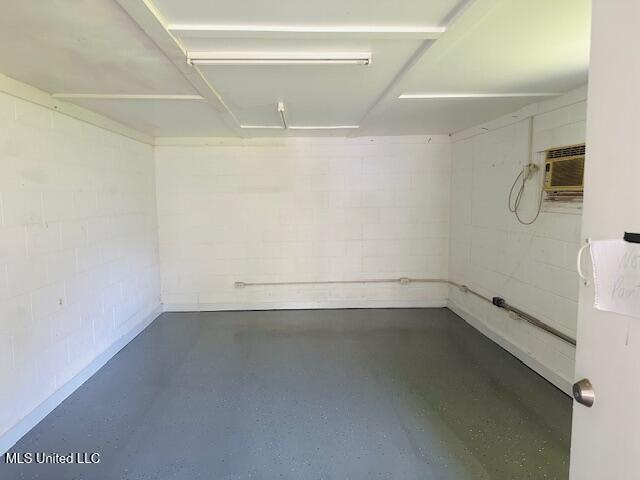 1561 Section Line Rd, Picayune, MS 39466 - garage featuring concrete block wall and a wall mounted AC