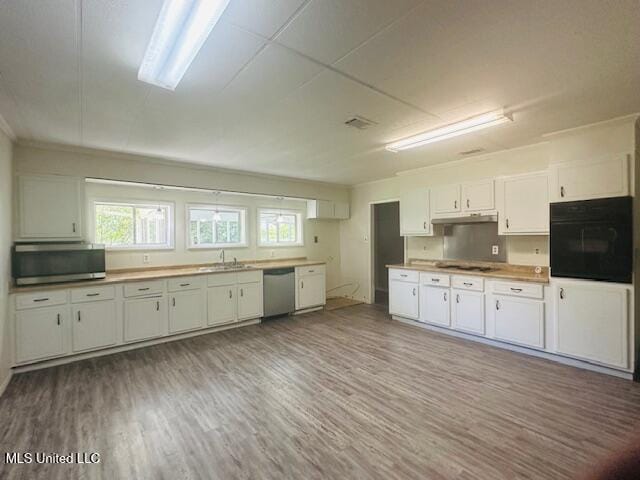 1561 Section Line Rd, Picayune, MS 39466 - kitchen featuring stainless steel appliances, a sink, wood finished floors, and healthy amount of natural light